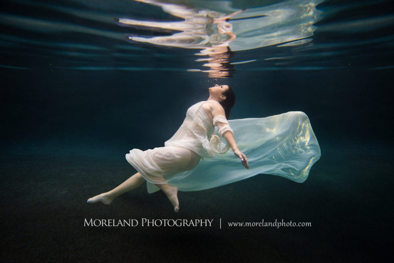 Woman in pearl dress underwater looking to the surface, underwater pictures, creative photography atlanta, creative edge workshops, moreland photography, creative underwater photo shoot, underwater photography, nikon underwater, Georgia underwater photo shoot, leading underwater photographer