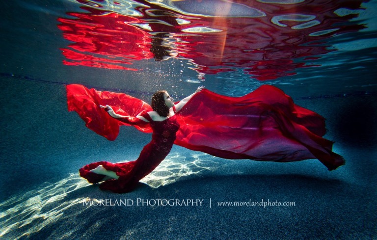 woman with flowing red dress posing underwater, underwater portraits for birthdays , creative photography atlanta, creative edge workshops, moreland photography, celebration photo shoot, underwater photography, nikon, birmingham underwater photography