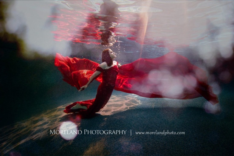 woman in red dress staring up at the surface underwater, underwater portraits, creative photography atlanta, creative edge workshops, moreland photography, celebration photo shoot, underwater photography, nikon, birmingham underwater photography, nikon photography, taking pictures underwater