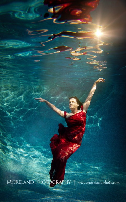 woman swimming underwater in red dress, underwater portraits, creative photography atlanta, creative edge workshops, moreland photography, celebration photo shoot, underwater photography, nikon, birmingham underwater photography