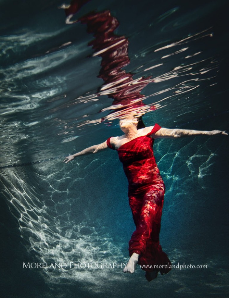 woman in red dress standing underwater coming up to the surface, underwater portraits, creative photography atlanta, creative edge workshops, moreland photography, birmingham underwater portraits , underwater photography, nikon photography, atlanta underwater photographer